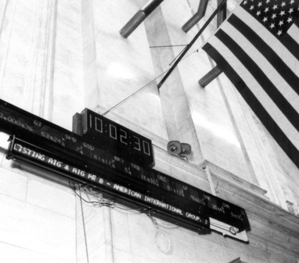 New York Stock Exchange trading board listing "American International Group" in 1984